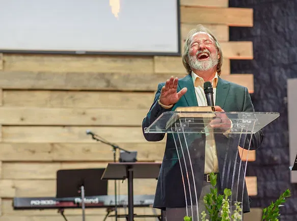 A pastor sharing a joyful, Bible-centered message during worship at Cornerstone Church