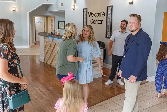 A welcoming Cornerstone Church family greeting one another in the lobby
