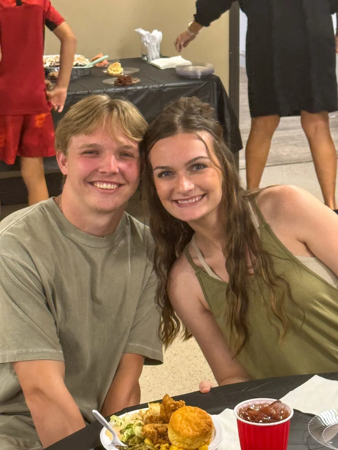 A young couple smiling together during a Cornerstone Church community meal