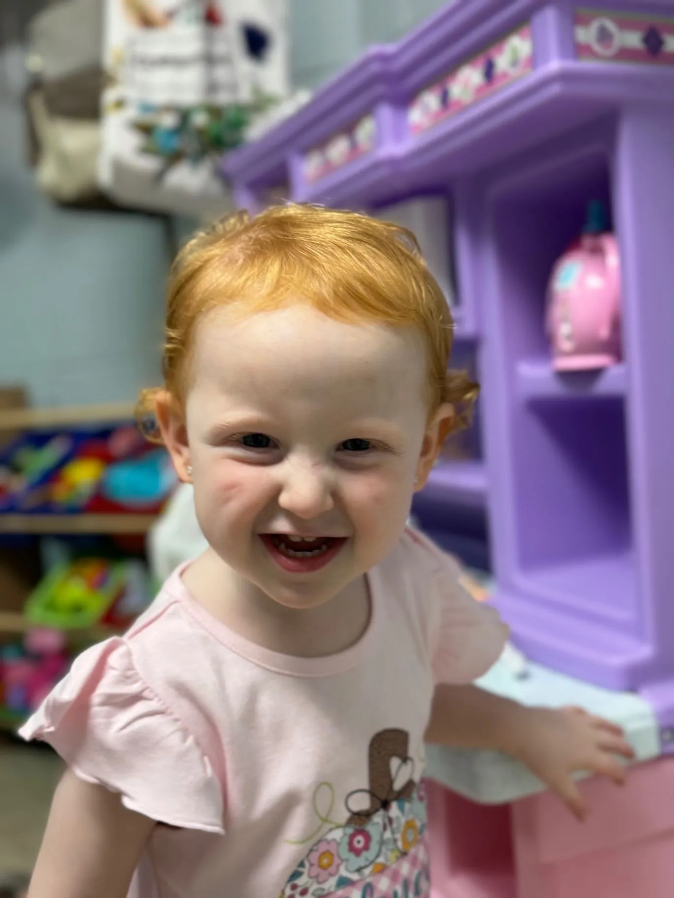 A smiling child in a Cornerstone Kids classroom