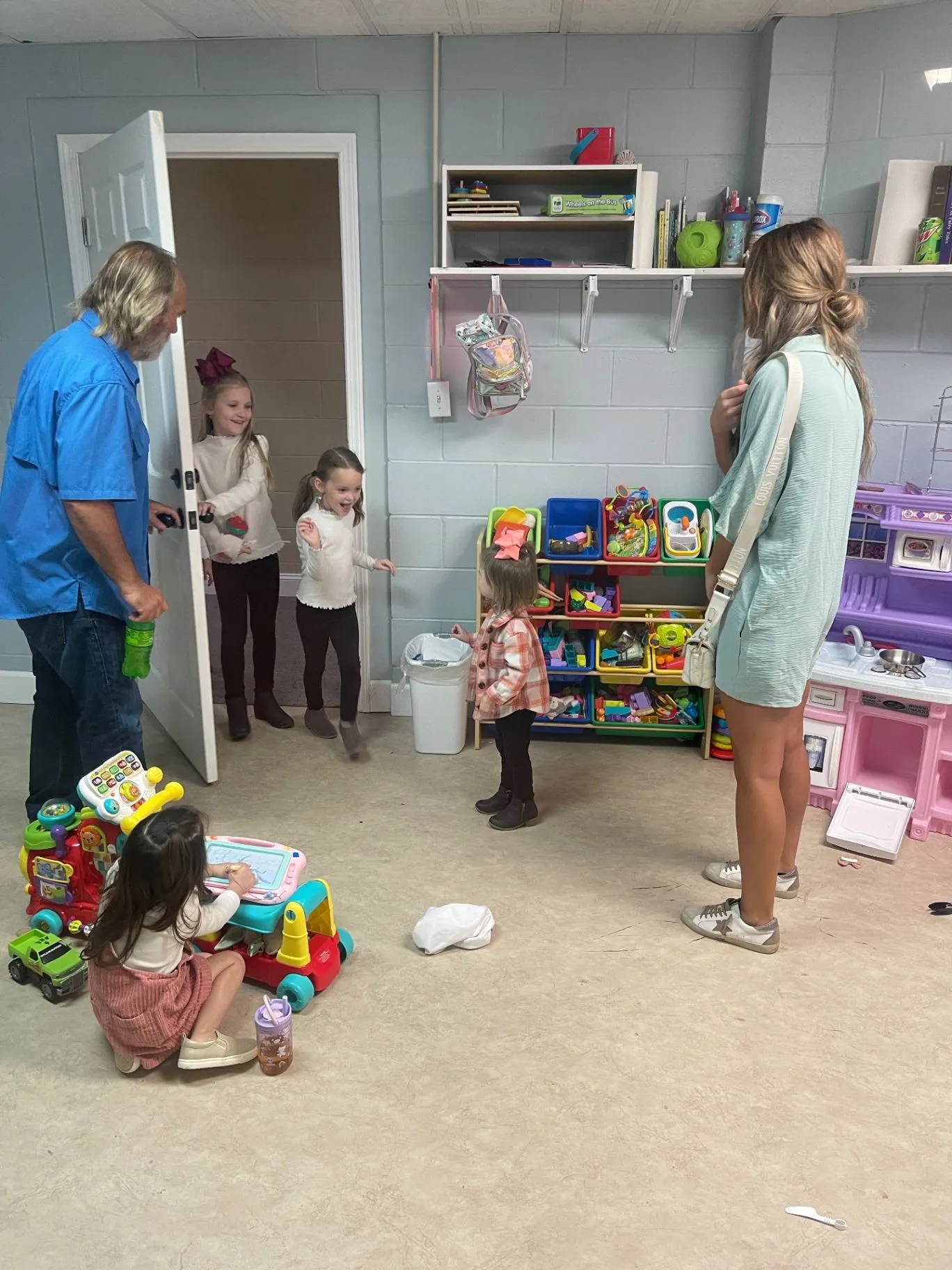 Children arriving with caregivers in the Cornerstone Kids room